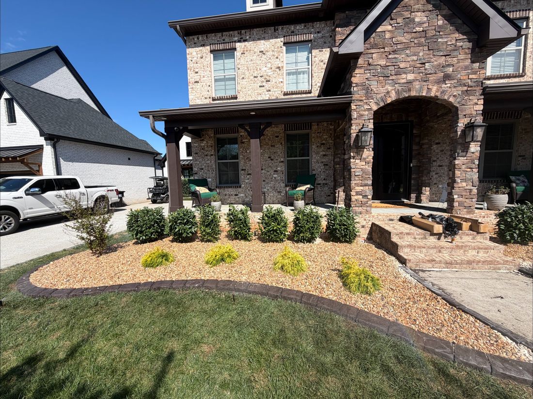 Stone landscape beds with evening uplighting
